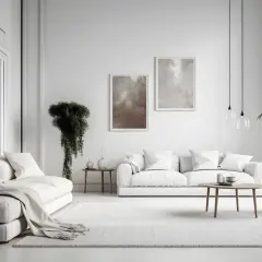 Minimalistyczny salon w stylu "cool white" - co to znaczy? Biel dominuje, tworząc przestronną, jasną atmosferę. Dwie sofy, stoliki, rośliny i obrazy.