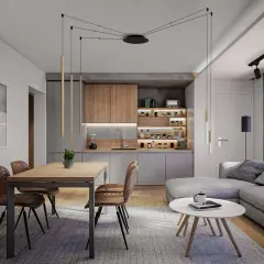 Nowoczesne oświetlenie nad narożnikiem tworzy przytulną atmosferę w salonie z aneksem kuchennym.