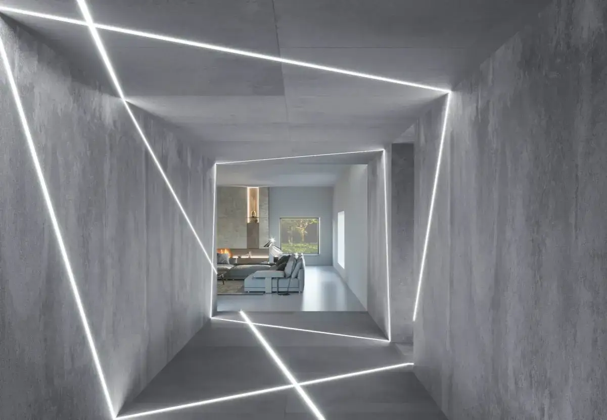 Nowoczesne aranżacje z profilem led podtynkowym tworzą geometryczne wzory na betonowych ścianach, prowadząc do salonu z kominkiem.